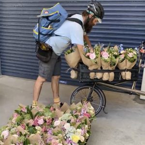 Close-up of a seasonal bouquet of anemones wrapped in white pape