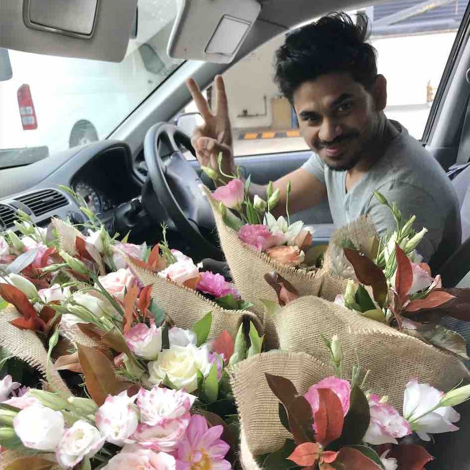 Car courier delivering flowers in Sydney with a peace sign
