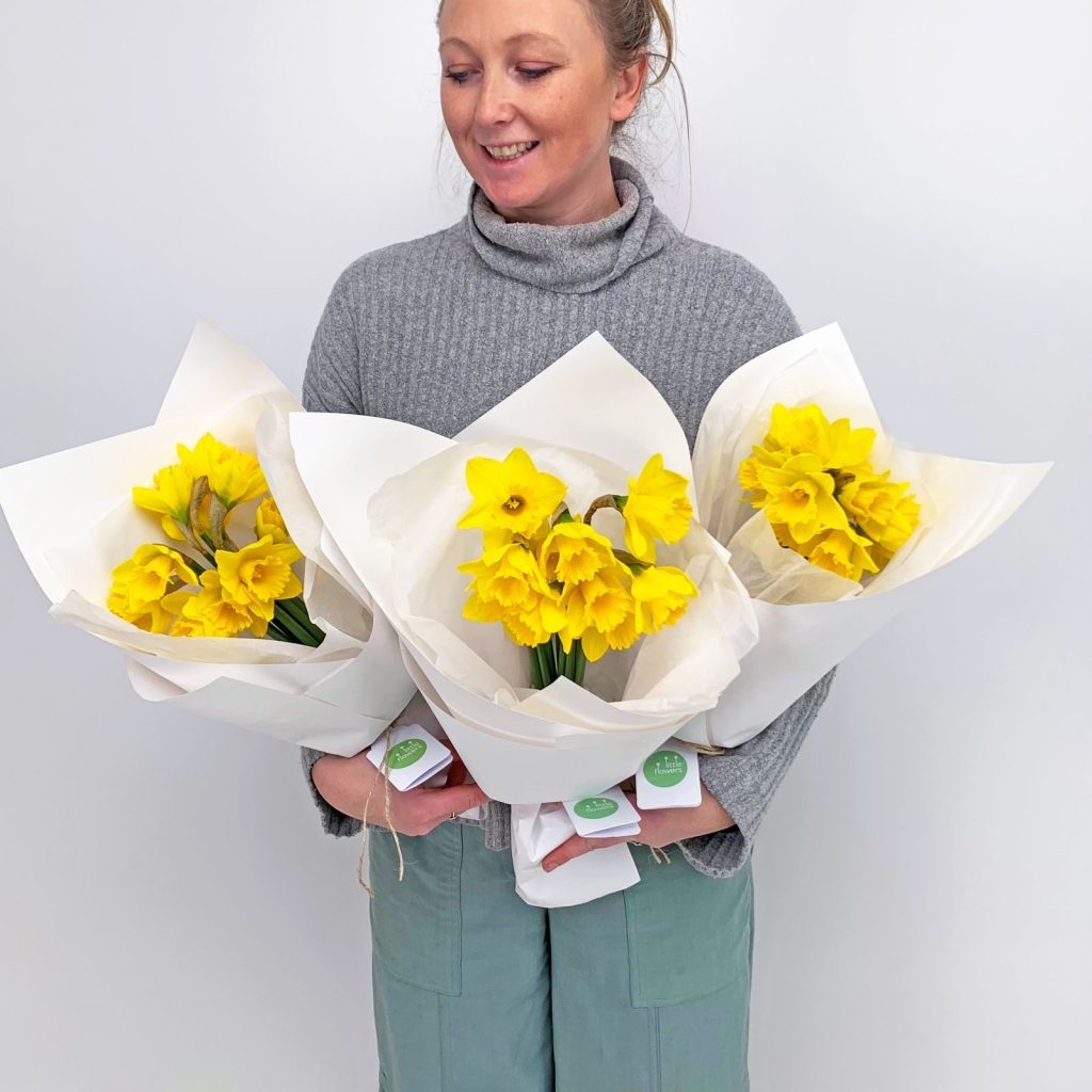 Florist with bright yellow daffodil bunches