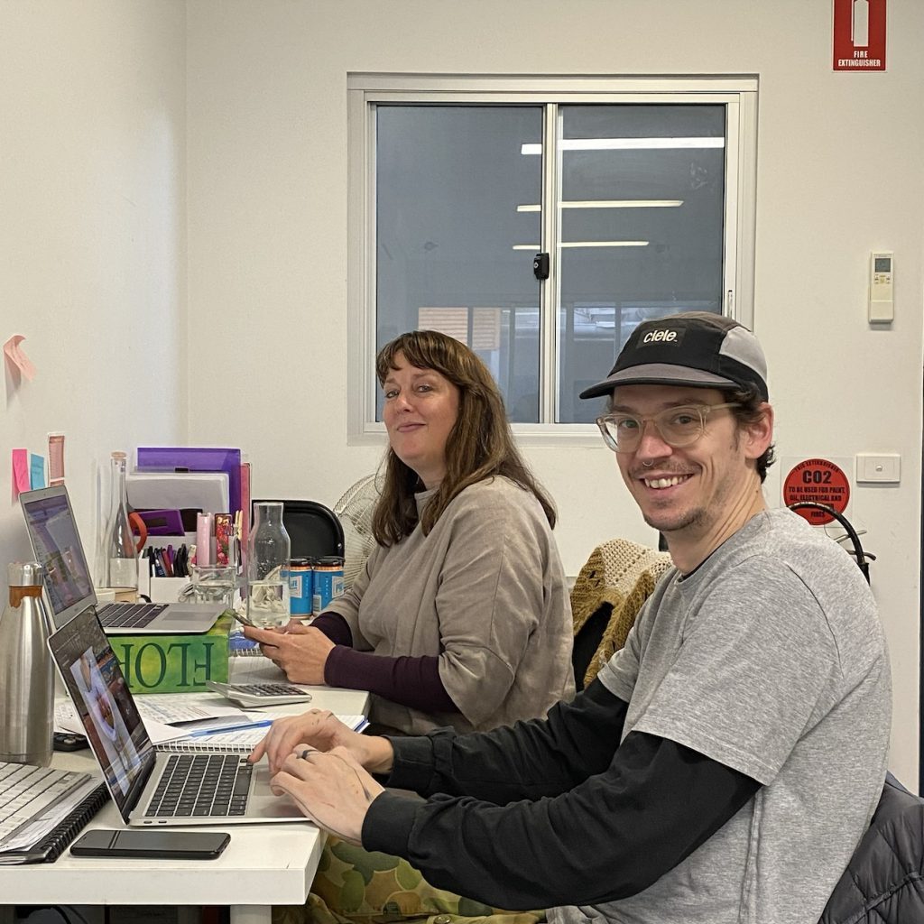 Two team members working at their desks in the Little Flowers HQ