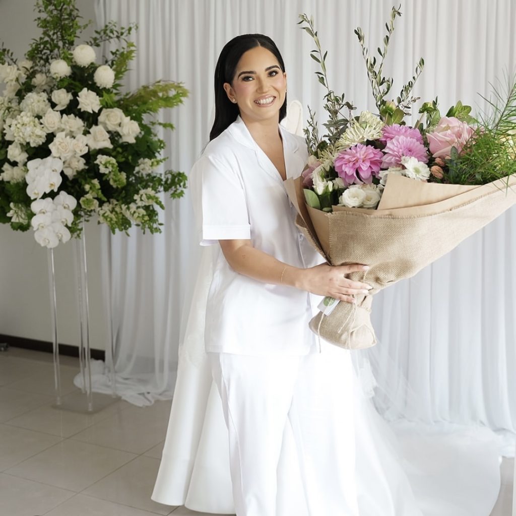 Smiling customer holding large Luxe bouquet with mixed flowers