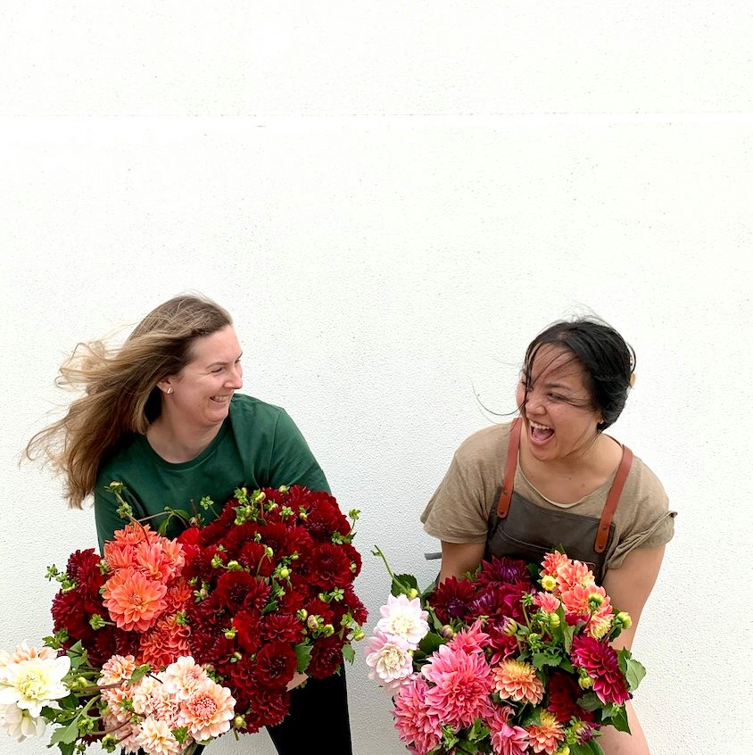 Two friends with bouquets